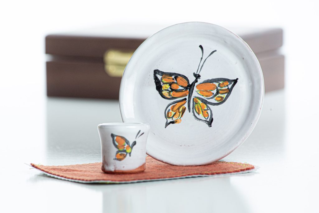 The set includes small cup, paten, Walnut box, and oil-cloth felt mat.