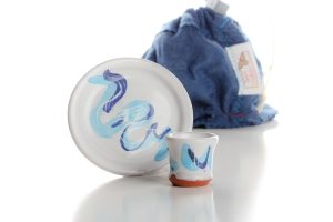 The set includes a cup, a paten, and a felt bag for transport and storage