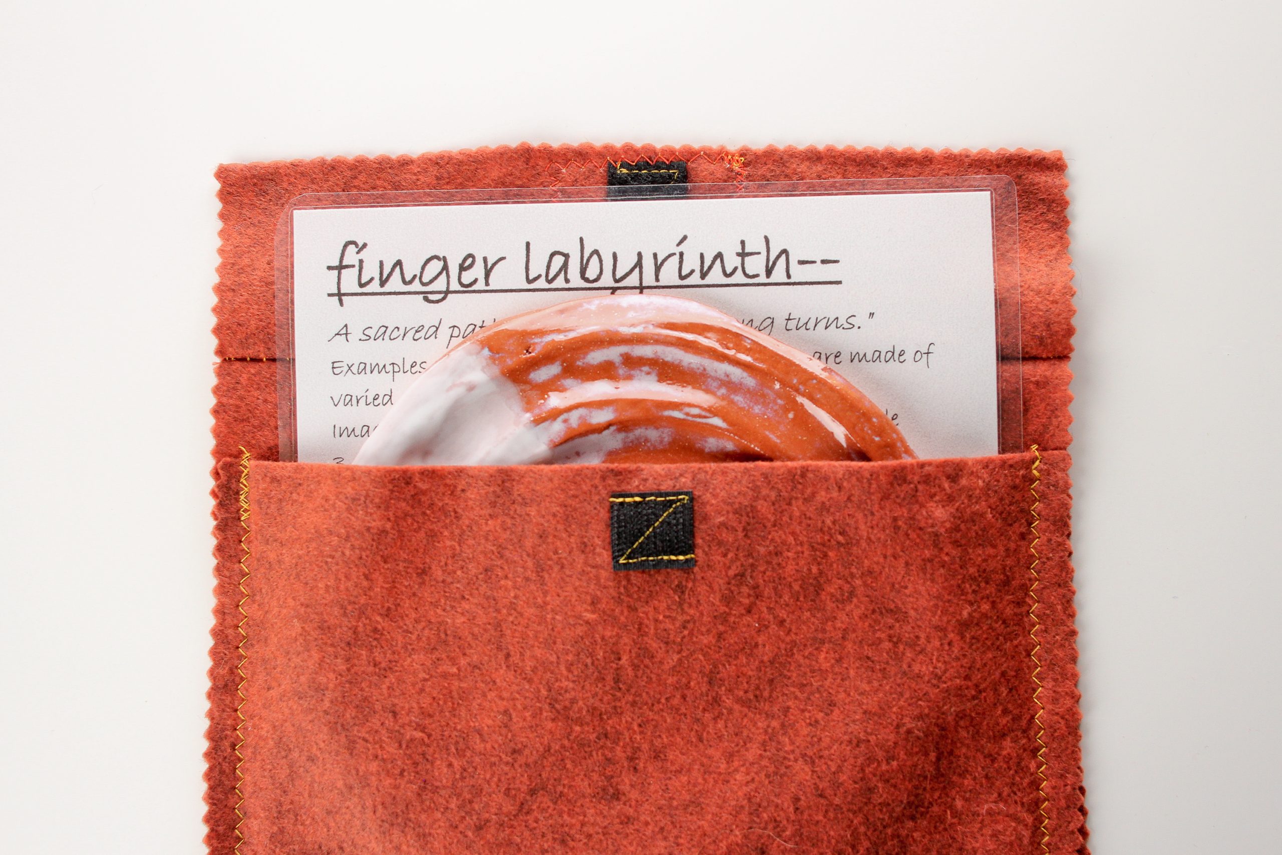 The finger labyrinth set includes a 'meaning of labyrinths' and instruction sheet and handmade cloth bag. Labyrinth measures approximately 7" wide.