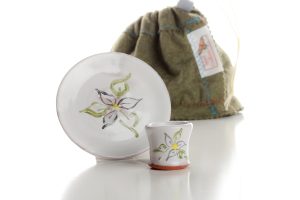 The set includes a cup, a paten, and a felt bag for transport and storage