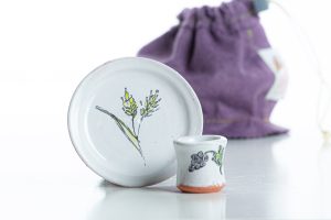 The set includes a cup, a paten, and a felt bag for transport and storage